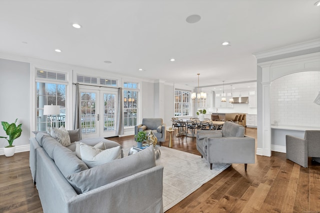 living area with crown molding, wood finished floors, baseboards, and recessed lighting