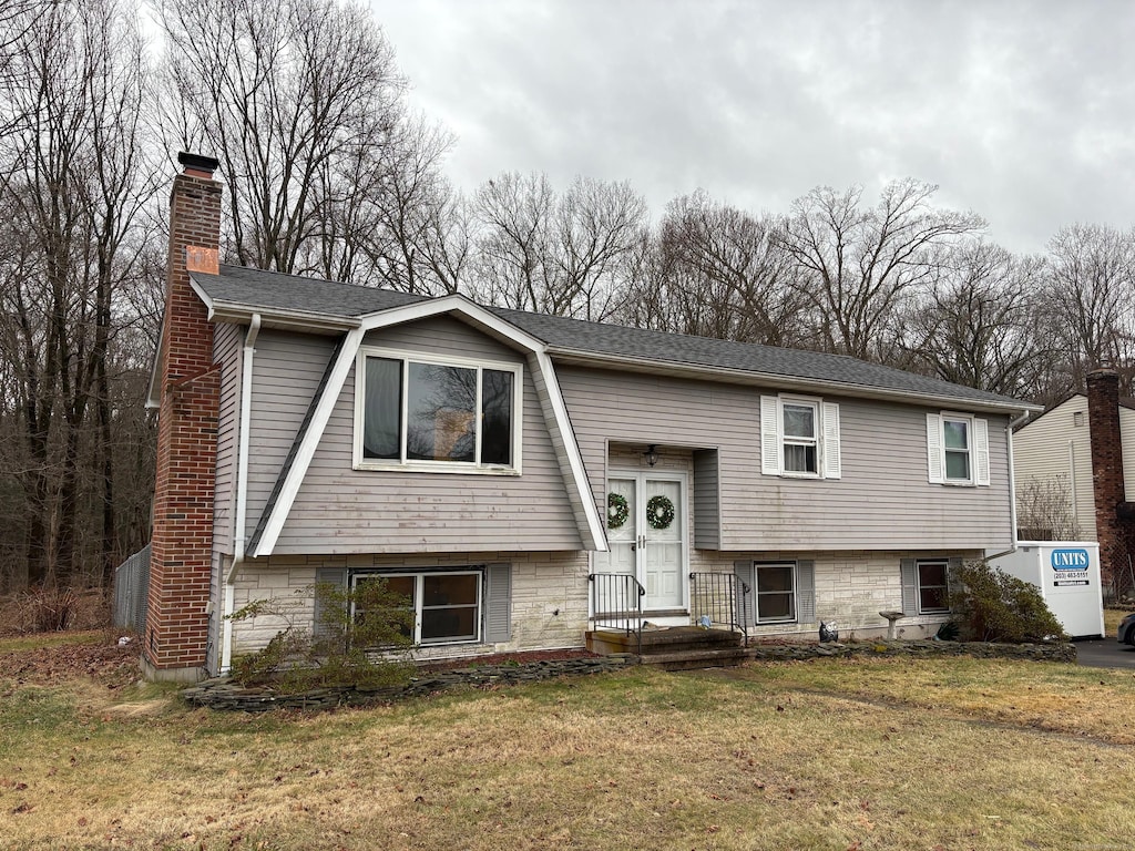 bi-level home with a front yard