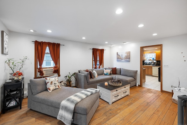 living room with cooling unit and light wood-type flooring