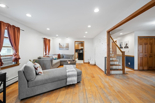 living room with a baseboard radiator and light hardwood / wood-style floors