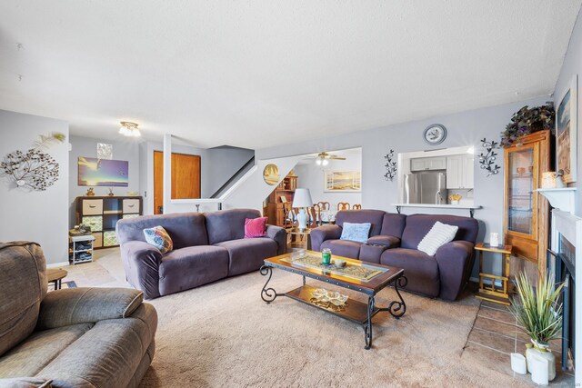 living room featuring ceiling fan and light colored carpet