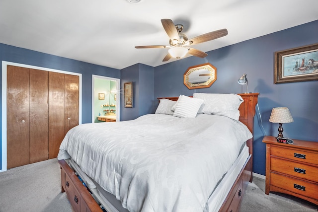 bedroom featuring ceiling fan, light colored carpet, connected bathroom, and a closet