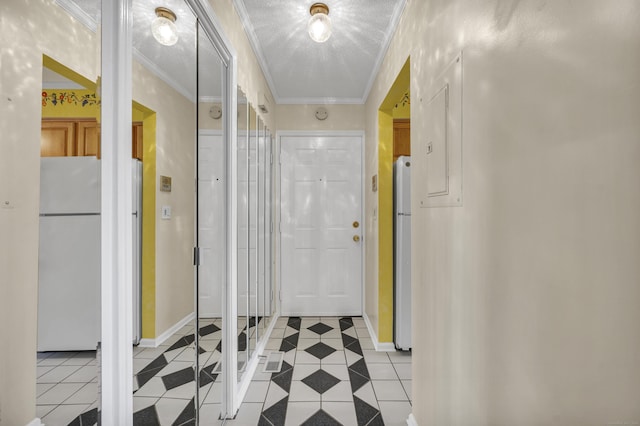 corridor featuring a textured ceiling, light tile patterned floors, and crown molding