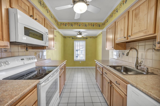 kitchen with white appliances, ceiling fan, crown molding, sink, and light tile patterned floors