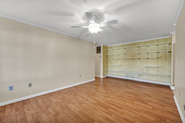 spare room with hardwood / wood-style floors, a textured ceiling, ceiling fan, and crown molding