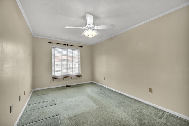 carpeted spare room with ceiling fan and ornamental molding