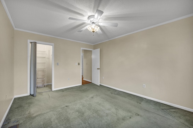 unfurnished bedroom with a textured ceiling, carpet floors, ceiling fan, and ornamental molding