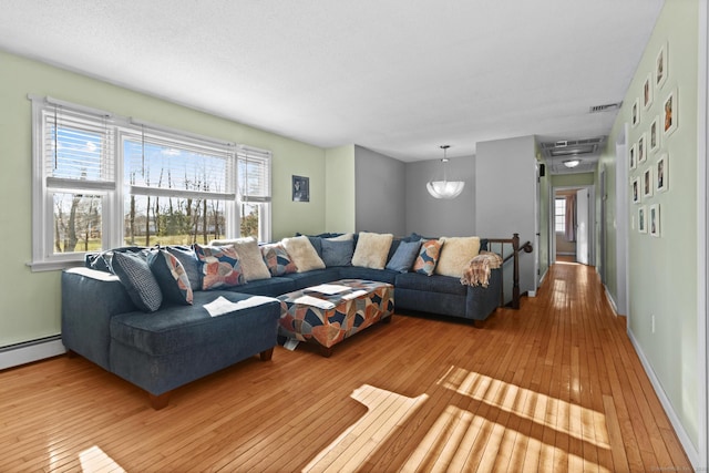 living room featuring light hardwood / wood-style floors and baseboard heating