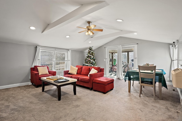 carpeted living room featuring ceiling fan and lofted ceiling with beams