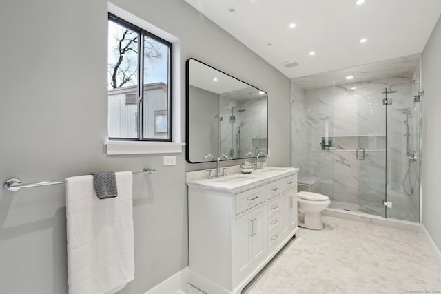 bathroom with vanity, walk in shower, and toilet