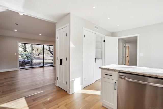 kitchen featuring white cabinetry, dishwasher, light stone countertops, and light hardwood / wood-style flooring