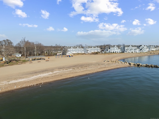 birds eye view of property featuring a water view and a view of the beach