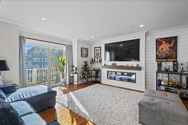 living room with hardwood / wood-style flooring and ornamental molding