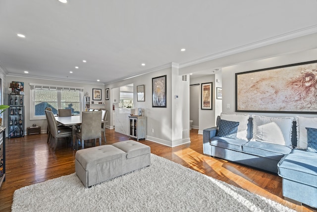 living room with hardwood / wood-style flooring and ornamental molding