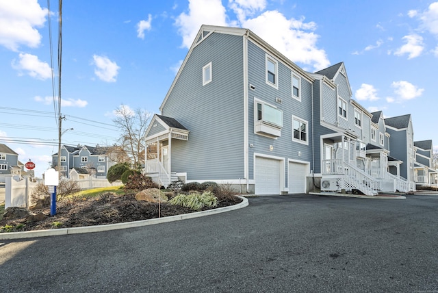 view of side of property featuring ac unit and a garage