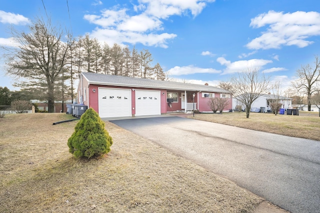 single story home with a front yard and a garage