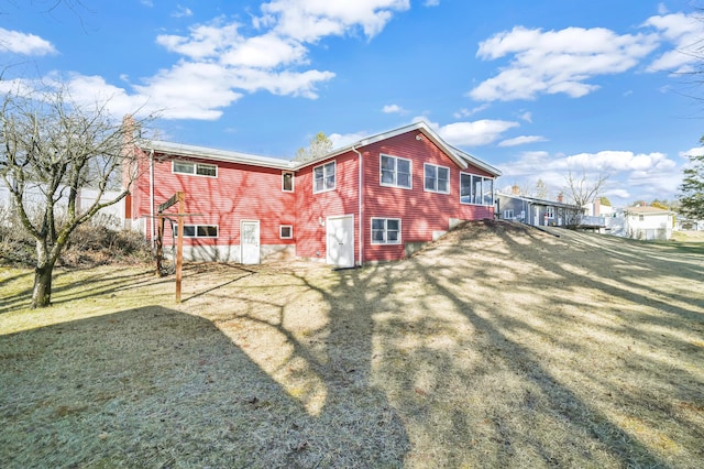 rear view of house with a yard