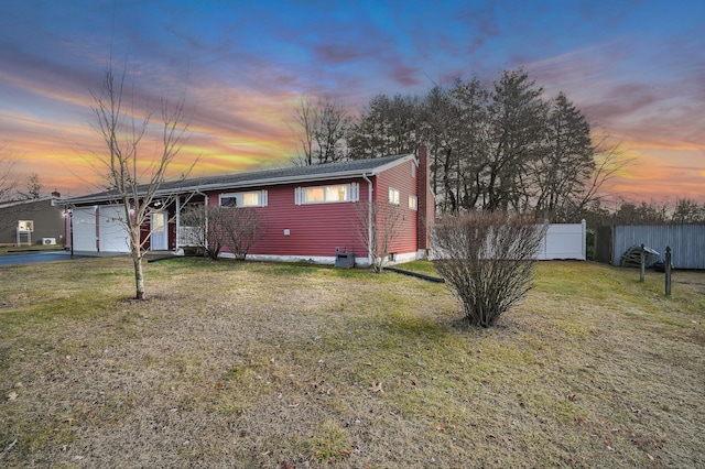 view of front of house with a yard and a garage