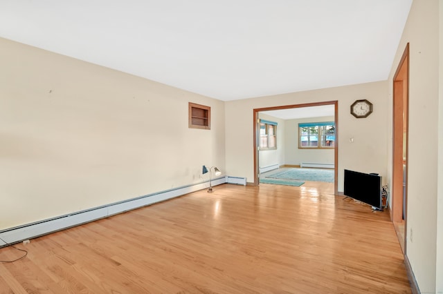 spare room featuring light hardwood / wood-style floors and a baseboard heating unit