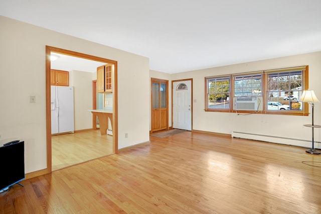 unfurnished living room featuring a baseboard radiator and light wood-type flooring