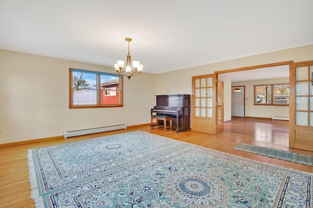 unfurnished living room featuring hardwood / wood-style floors, a chandelier, french doors, and a baseboard radiator