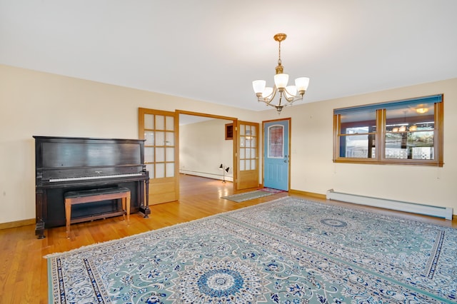 living room featuring a chandelier, wood-type flooring, french doors, and a baseboard heating unit