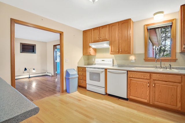 kitchen featuring white appliances, a baseboard heating unit, sink, tasteful backsplash, and light hardwood / wood-style floors