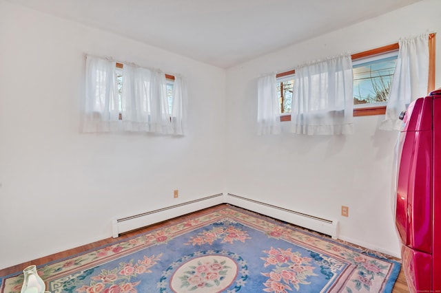 unfurnished room featuring a baseboard heating unit