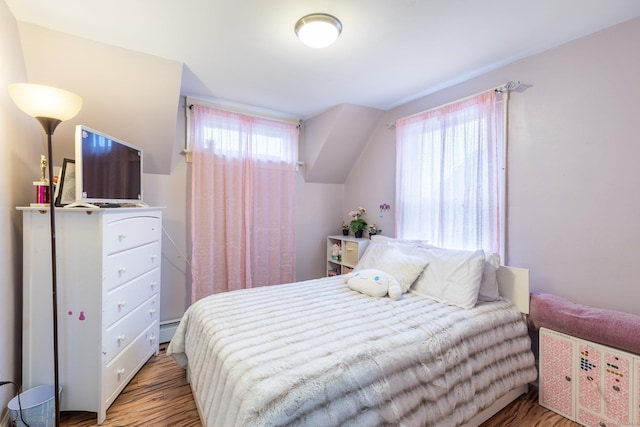 bedroom featuring hardwood / wood-style floors and a baseboard radiator