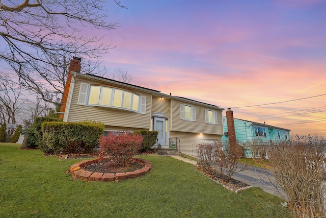 bi-level home featuring a lawn