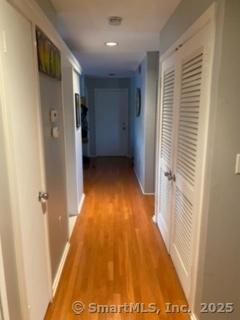 corridor with light hardwood / wood-style floors