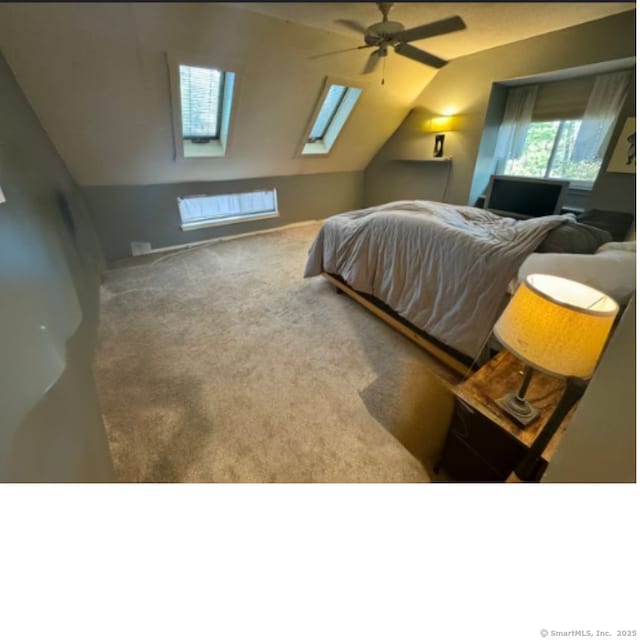 bedroom with ceiling fan, carpet, and vaulted ceiling