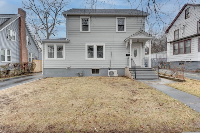 view of front of house featuring ac unit and a front lawn