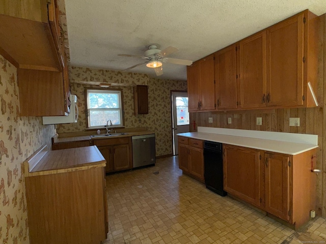 kitchen with ceiling fan, sink, stainless steel dishwasher, and a textured ceiling