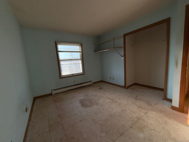 unfurnished bedroom featuring a closet and a baseboard heating unit