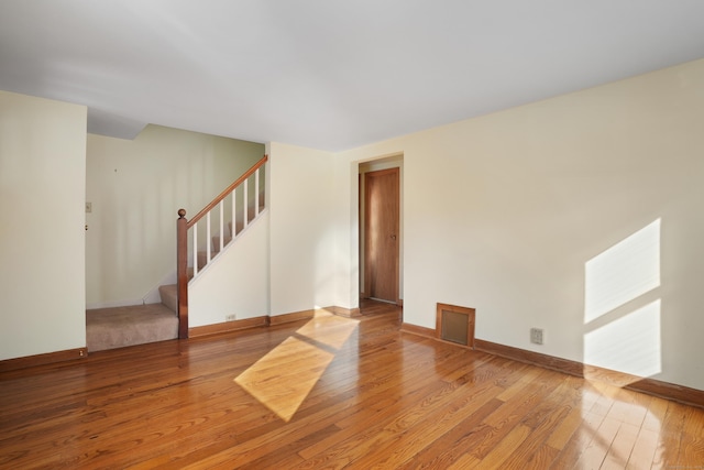 spare room with hardwood / wood-style floors