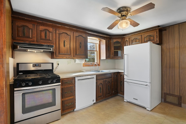 kitchen with dark brown cabinetry, ceiling fan, sink, and white appliances