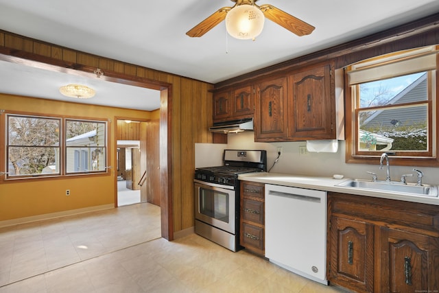 kitchen featuring gas range, ceiling fan, dishwasher, and sink