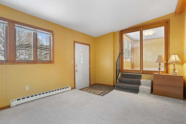 entrance foyer featuring carpet flooring, a baseboard radiator, and vaulted ceiling