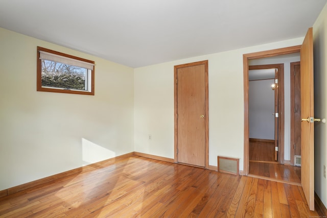 unfurnished bedroom with hardwood / wood-style flooring