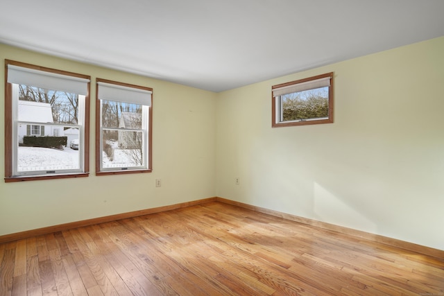 empty room with plenty of natural light and light wood-type flooring