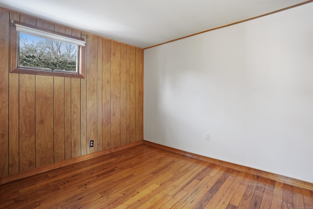 unfurnished room featuring crown molding and light wood-type flooring