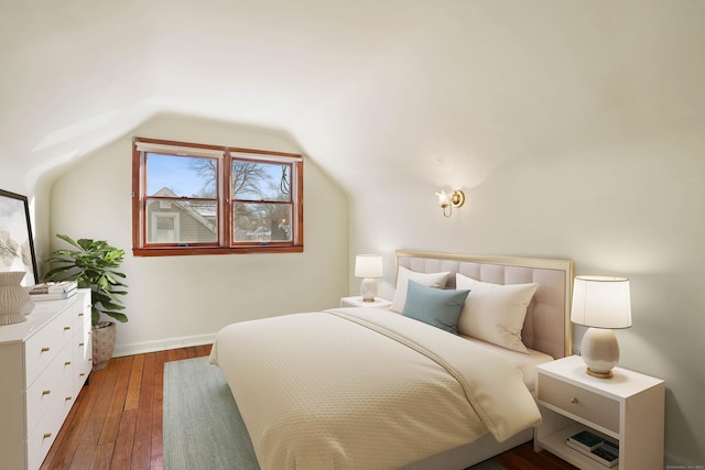 bedroom featuring dark hardwood / wood-style floors and lofted ceiling