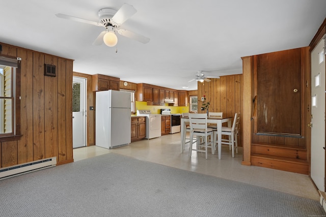 kitchen featuring white appliances, washer / clothes dryer, ceiling fan, and wooden walls