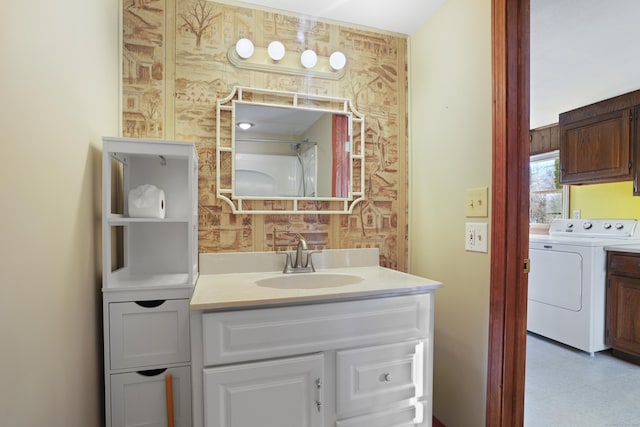 bathroom featuring vanity and independent washer and dryer