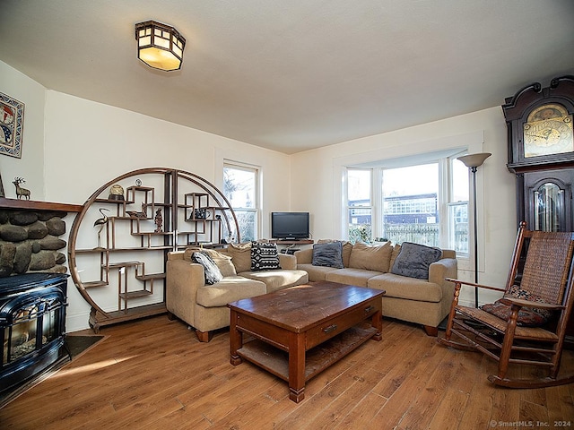 living room featuring a wood stove and hardwood / wood-style flooring