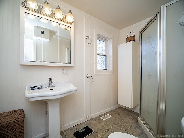 bathroom featuring sink and an enclosed shower