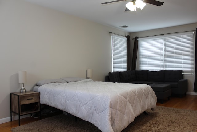 bedroom with ceiling fan and hardwood / wood-style flooring