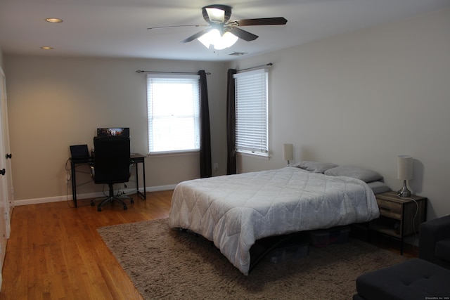 bedroom with ceiling fan and wood-type flooring