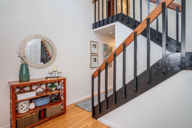 stairs with hardwood / wood-style flooring